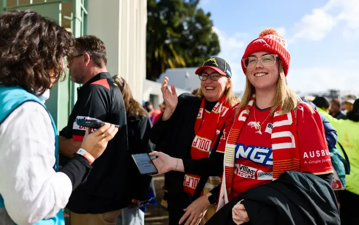 Two women having their tickets scanned
