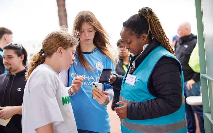 Two girls having their tickets scanned