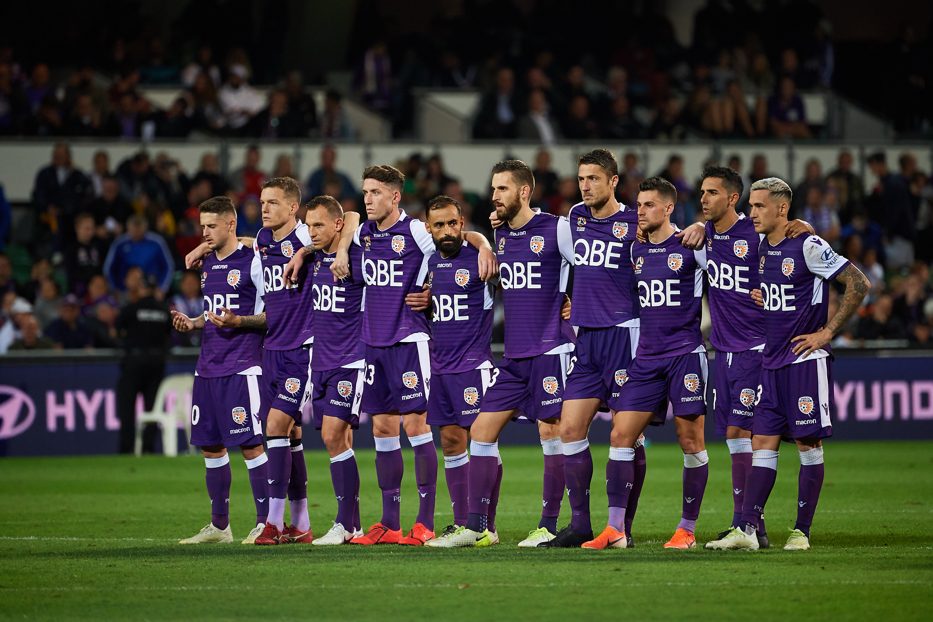A photo of the Perth Glory team linking arms together