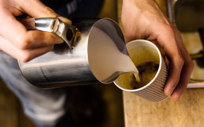 Takeaway coffee being poured