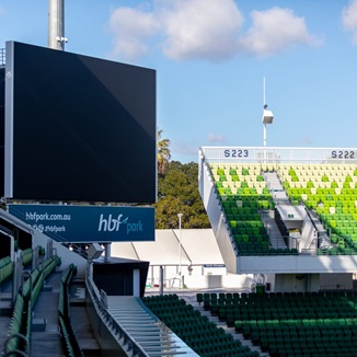 A photo taken of the large viewing screen in the corner of the HBF Park field
